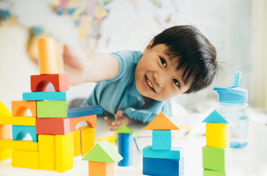 An image of a Boy building with blocks