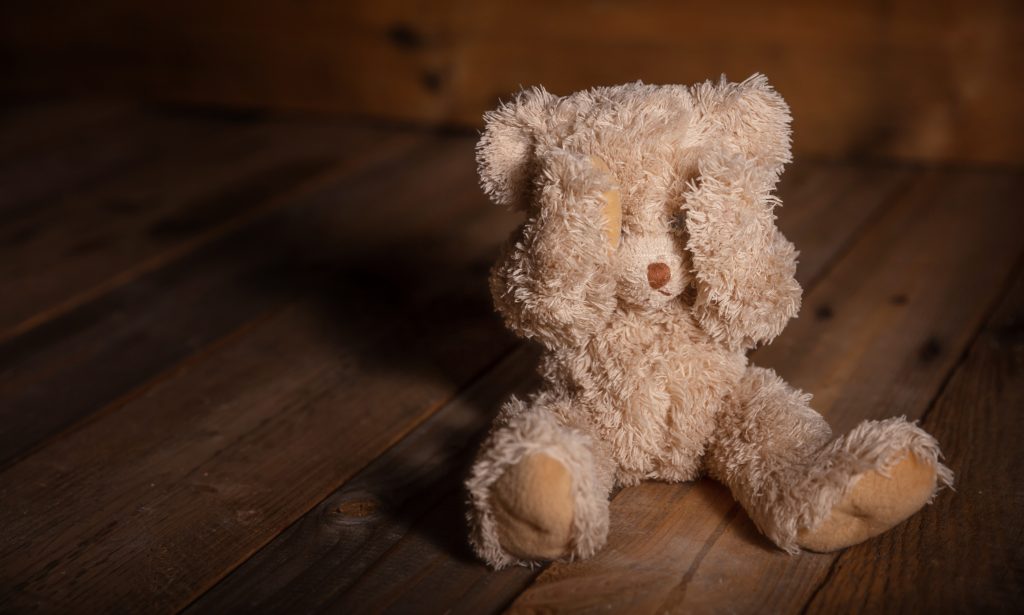 Child abuse Teddy bear covering eyes