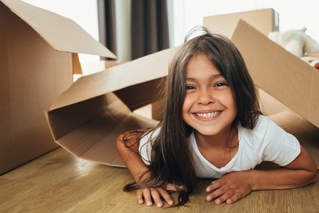 An image of a little girl playing with Cardboard Box