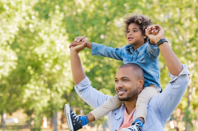 Father with child on his shoulders