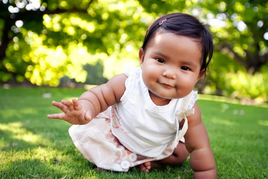 An image of a cute baby girl with a smile on her face