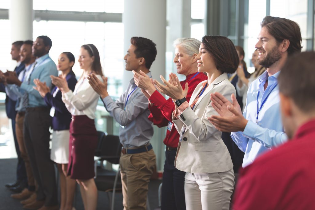 An image of happy business people applauding in a business seminar
